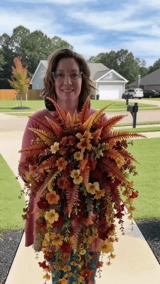 Animated preview of cascading orange and yellow fall flowers in outdoor display settings