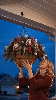 Animated preview of a lit Christmas hanging basket being displayed on a porch